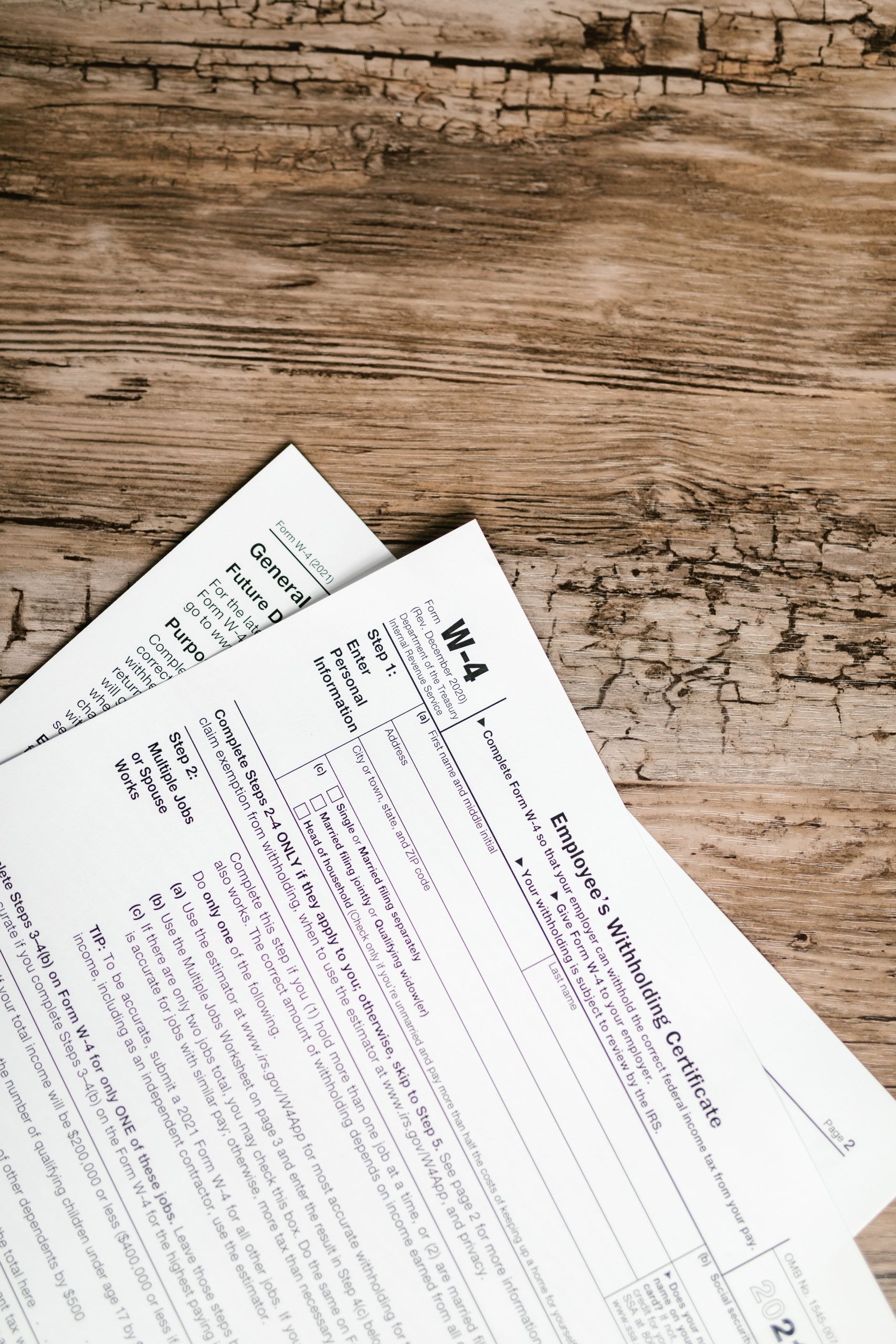 Detailed shot of tax forms on a wooden surface, ideal for concept themes like finance and documentation.